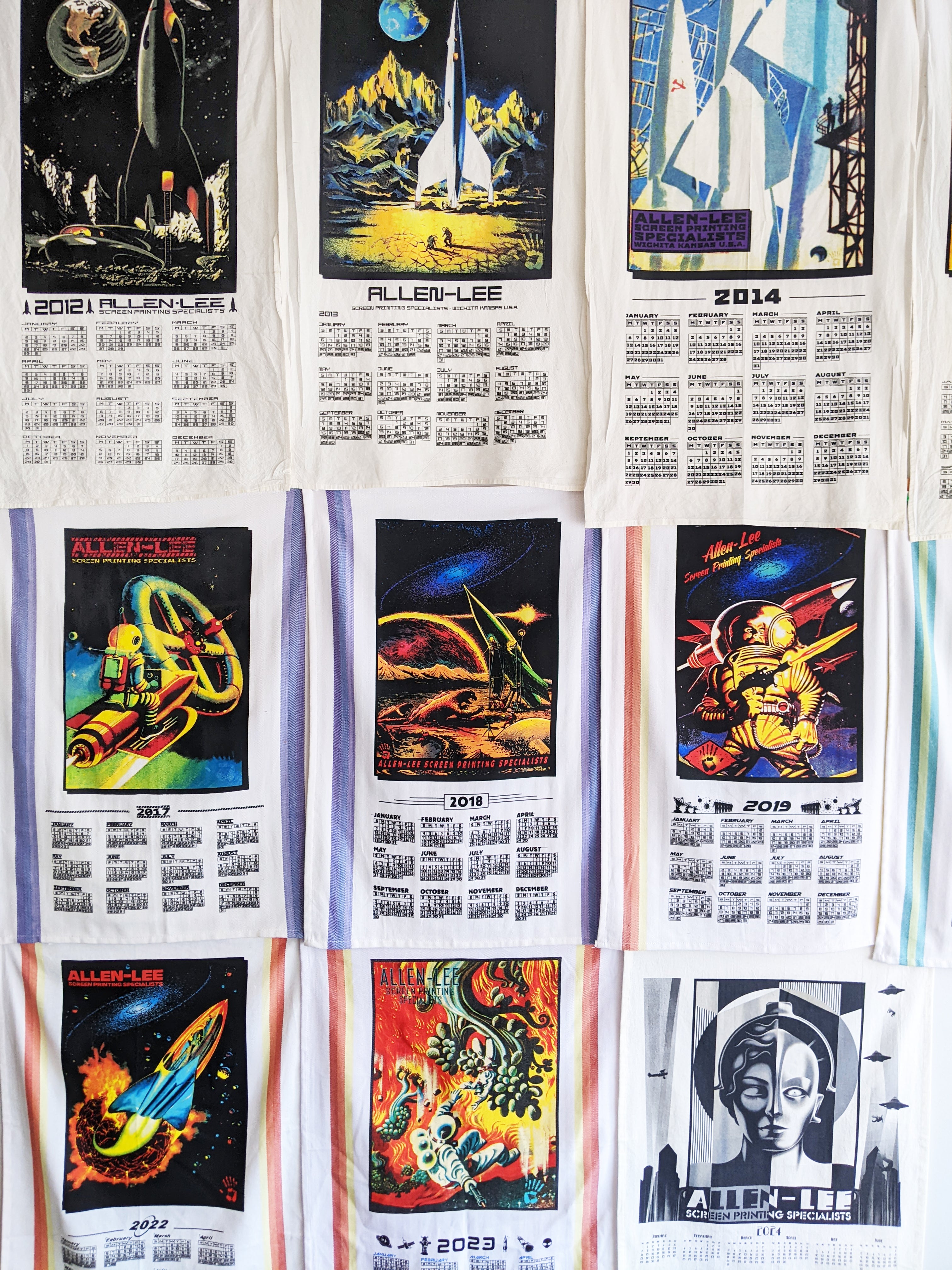 A photograph of screen printed calendars inspired by retro-futurist art.